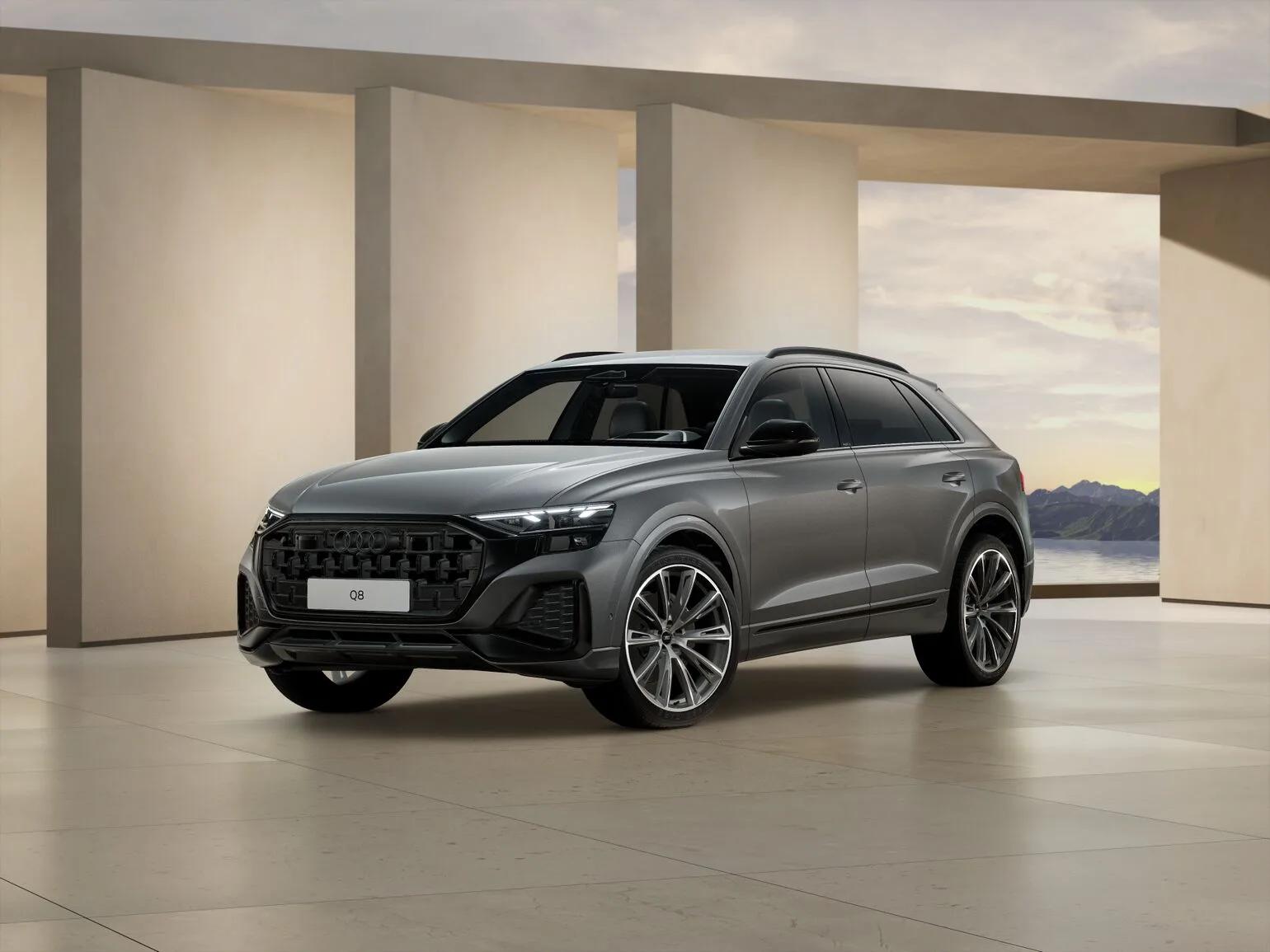 Szare Audi Q8 TDI quattro tiptronic 2026, ujęcie z przodu pod kątem, w jasnym nowoczesnym wnętrzu salonowym