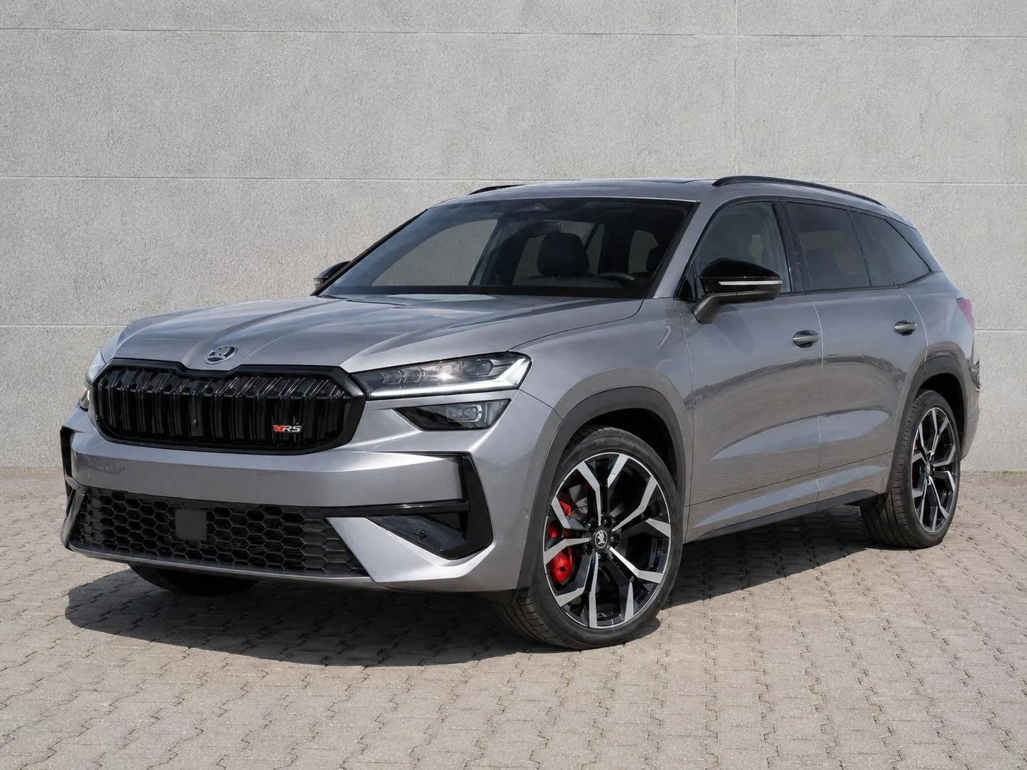 Szara Škoda Kodiaq RS, widok z przodu i boku, czarny grill, duże felgi i czerwone zaciski hamulców