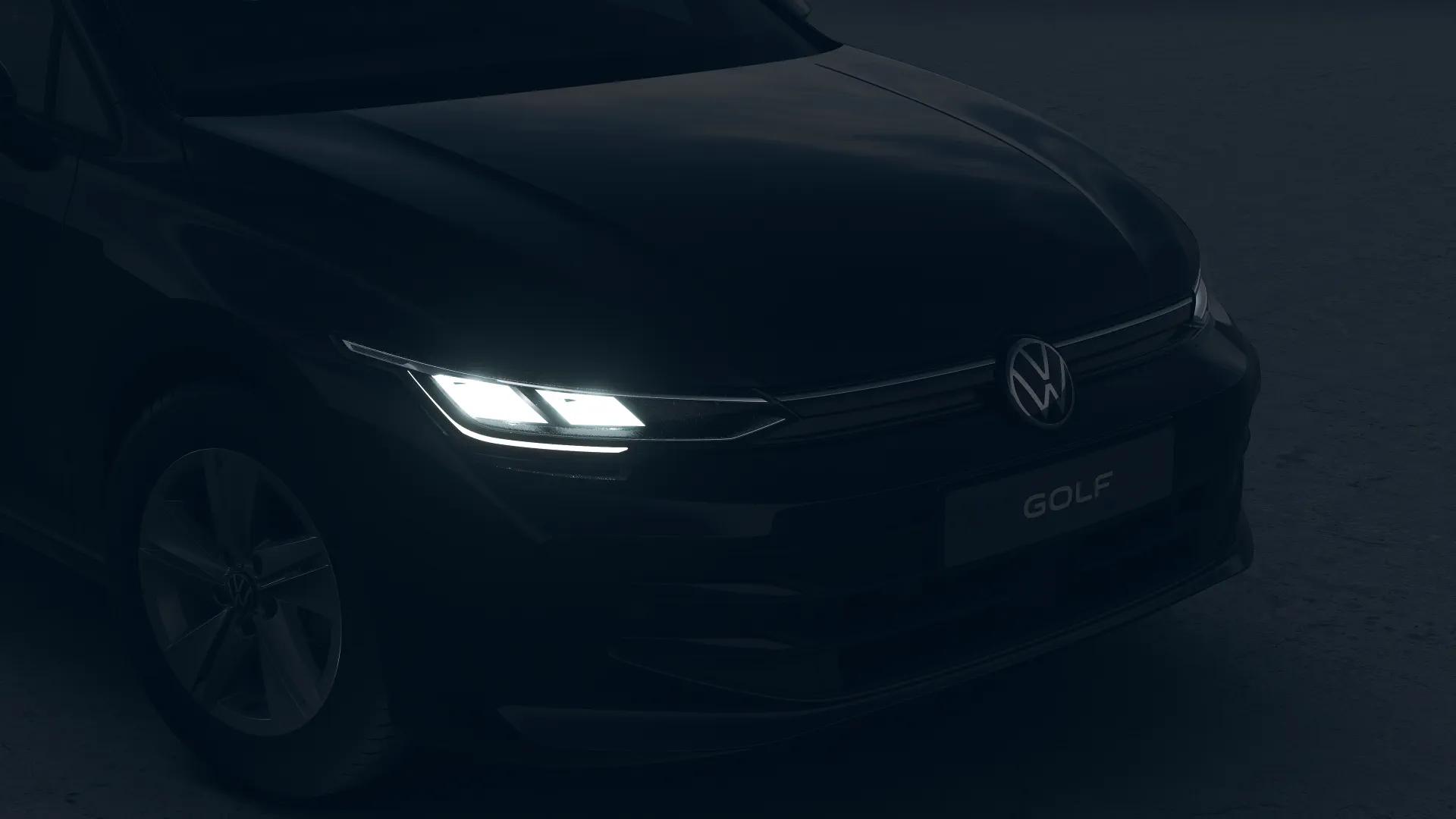 Ciemny Volkswagen Golf Variant z przodu, z włączonymi reflektorami LED i widocznym logo Volkswagena